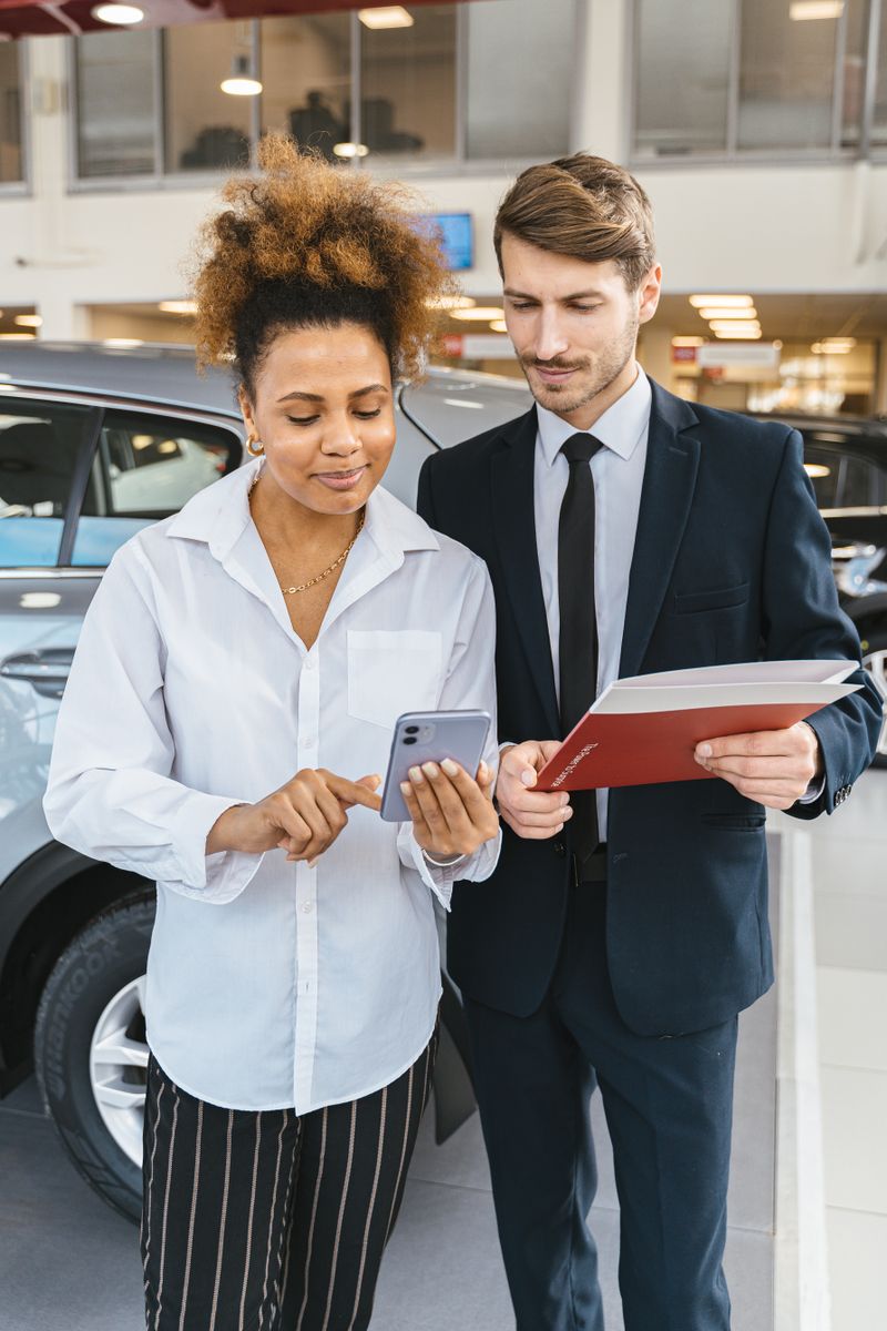 College students loading luggage into a rental car for a road trip