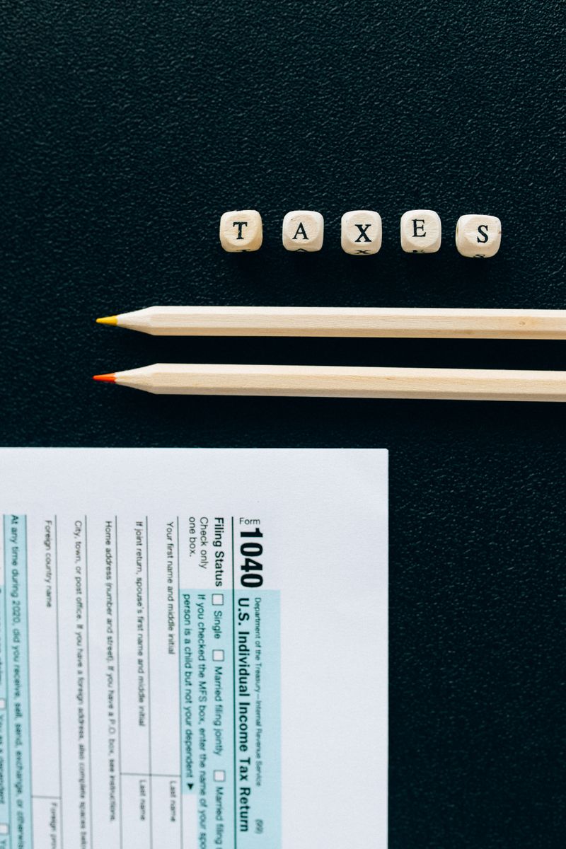 Person writing a formal appeal letter with documents spread on a desk
