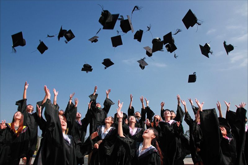 College graduate celebrating with cap