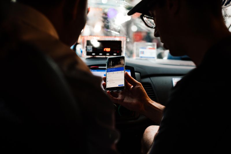 Driver using rideshare app on smartphone