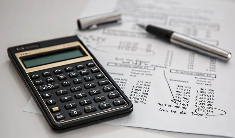 Calculator and finance documents for insurance planning