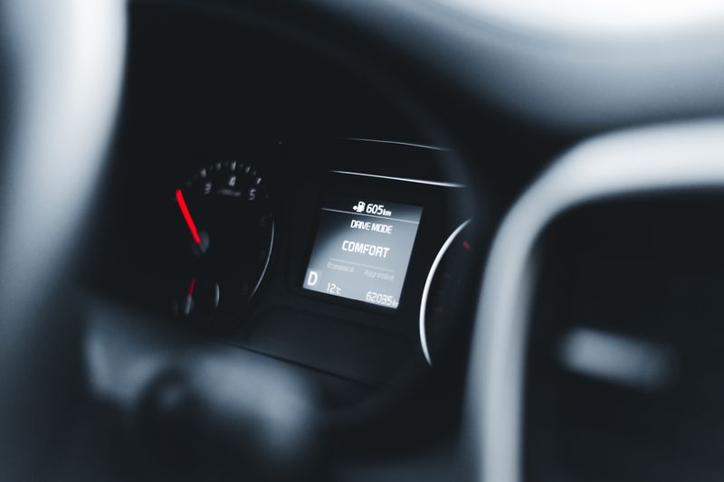 Car dashboard with digital display and steering wheel
