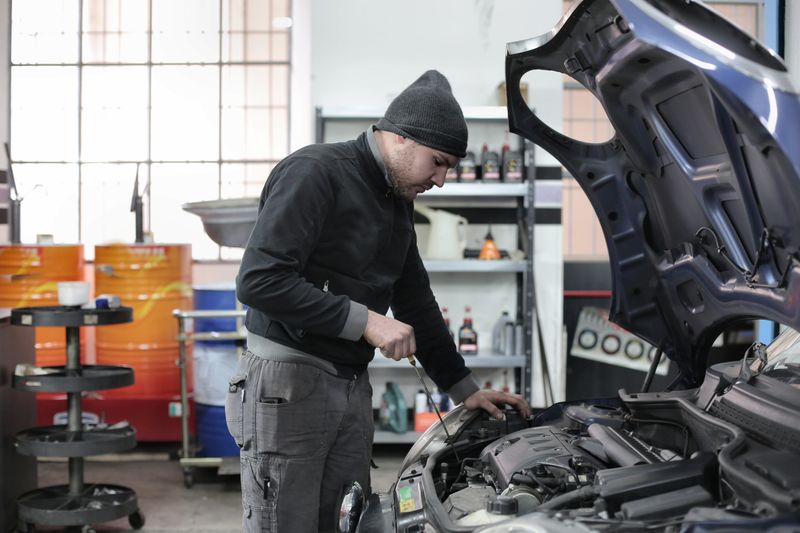 Mechanic inspecting used car pre-purchase inspection