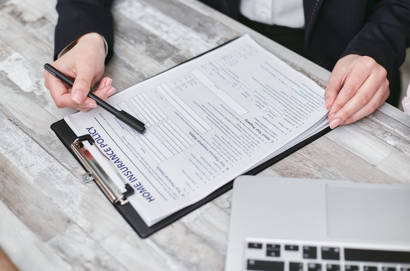 insurance policy documents on table
