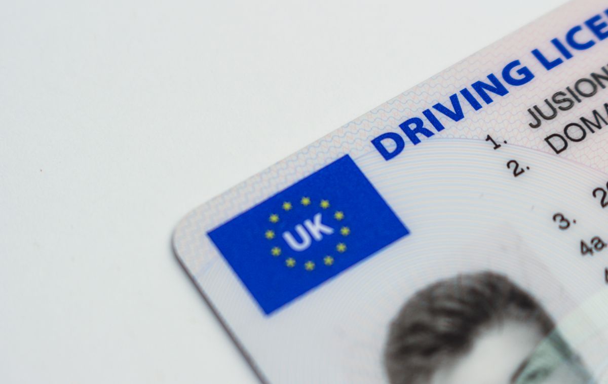 Driver's license and car insurance card lying on a desk