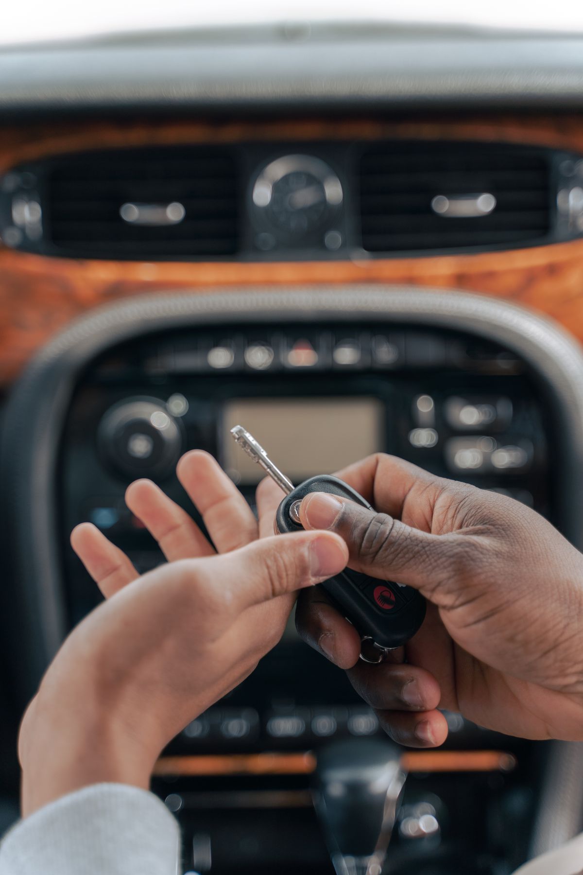 Teen holding car keys by a vehicle